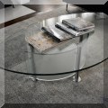 F05. Glass coffee table. 17"h x 57"w x 34"d 